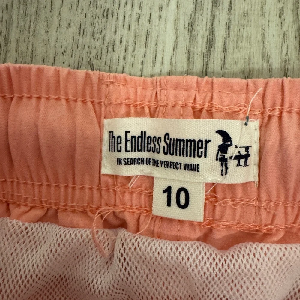 The Endless Summer Kids Swim Trunks in Orange pink color